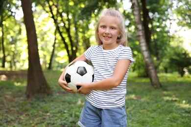 Photo of Cute little girl with soccer ball in park