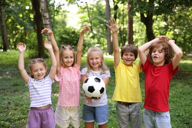 Photo of Cute little kids with soccer ball in park