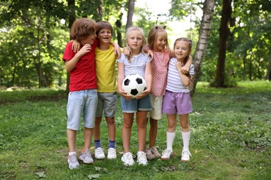 Photo of Cute little kids with soccer ball in park