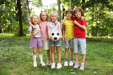 Photo of Cute little kids with soccer ball in park