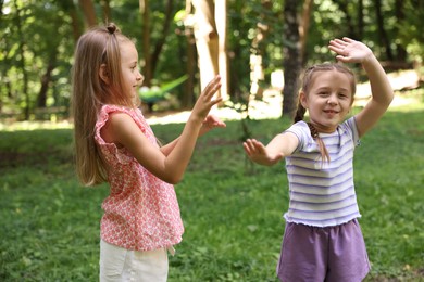 Photo of Cute little kids having fun together in park