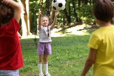 Photo of Cute little kids playing with soccer ball in park