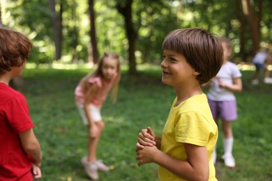 Photo of Cute little kids having fun together in park, selective focus