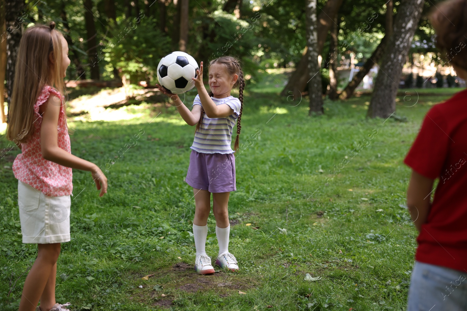 Photo of Cute little kids playing with soccer ball in park