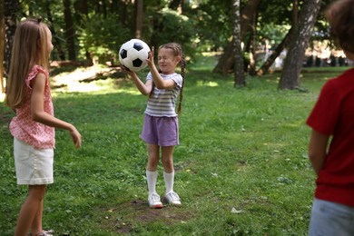 Photo of Cute little kids playing with soccer ball in park