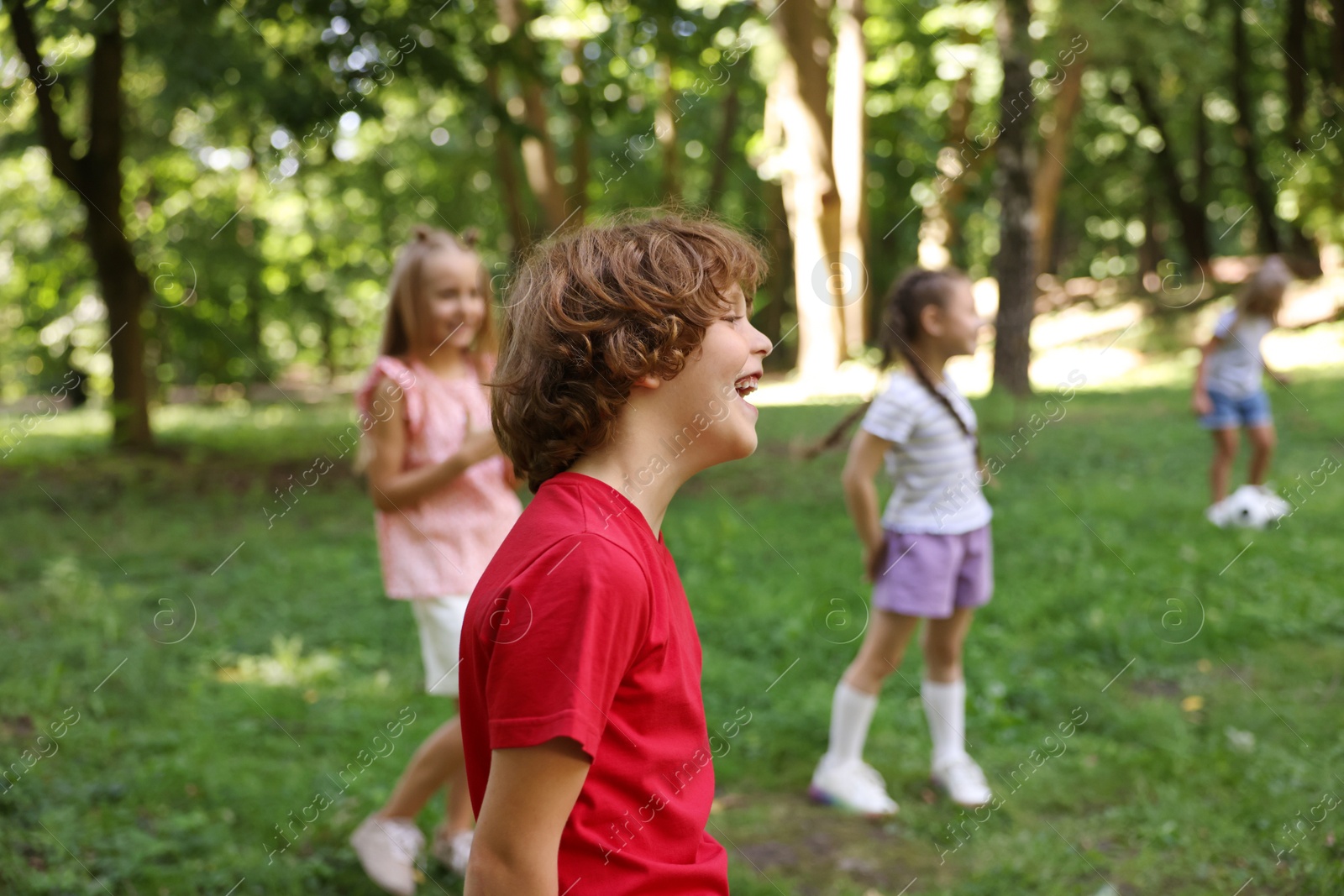 Photo of Cute little kids having fun together in park, selective focus