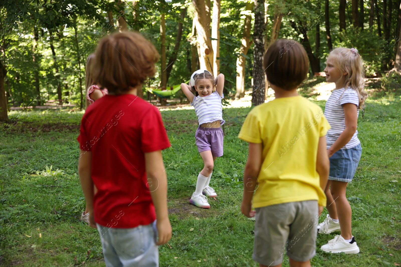 Photo of Cute little kids playing with soccer ball in park