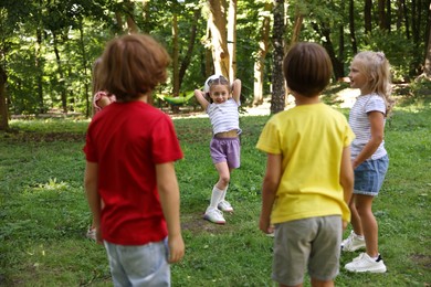 Photo of Cute little kids playing with soccer ball in park
