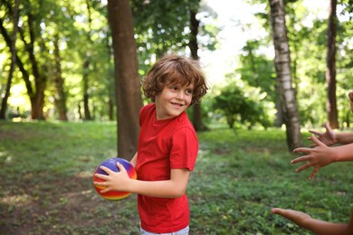 Photo of Cute little kids playing with ball in park