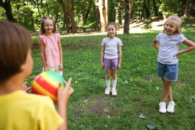 Photo of Cute little kids playing with ball in park
