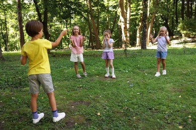 Photo of Cute little kids having fun together in park