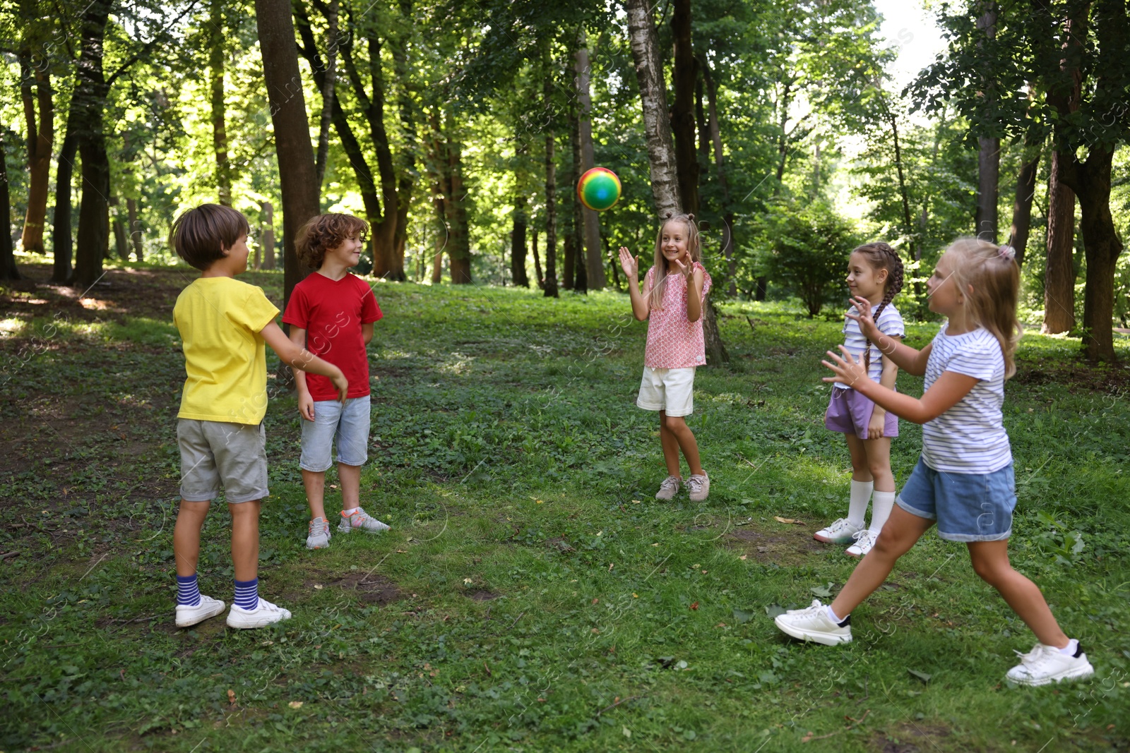 Photo of Cute little kids playing with ball in park