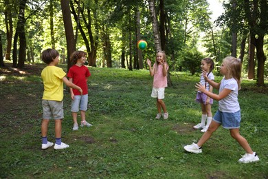 Photo of Cute little kids playing with ball in park
