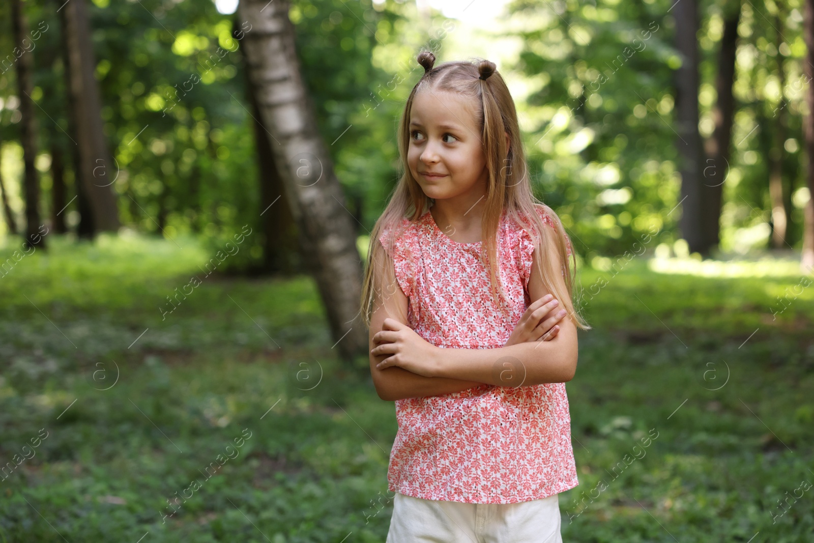 Photo of Cute little girl in park, space for text