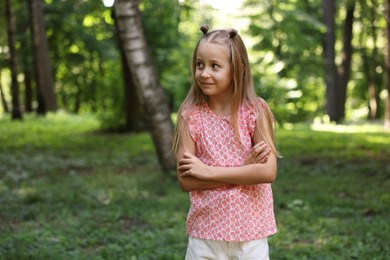 Photo of Cute little girl in park, space for text