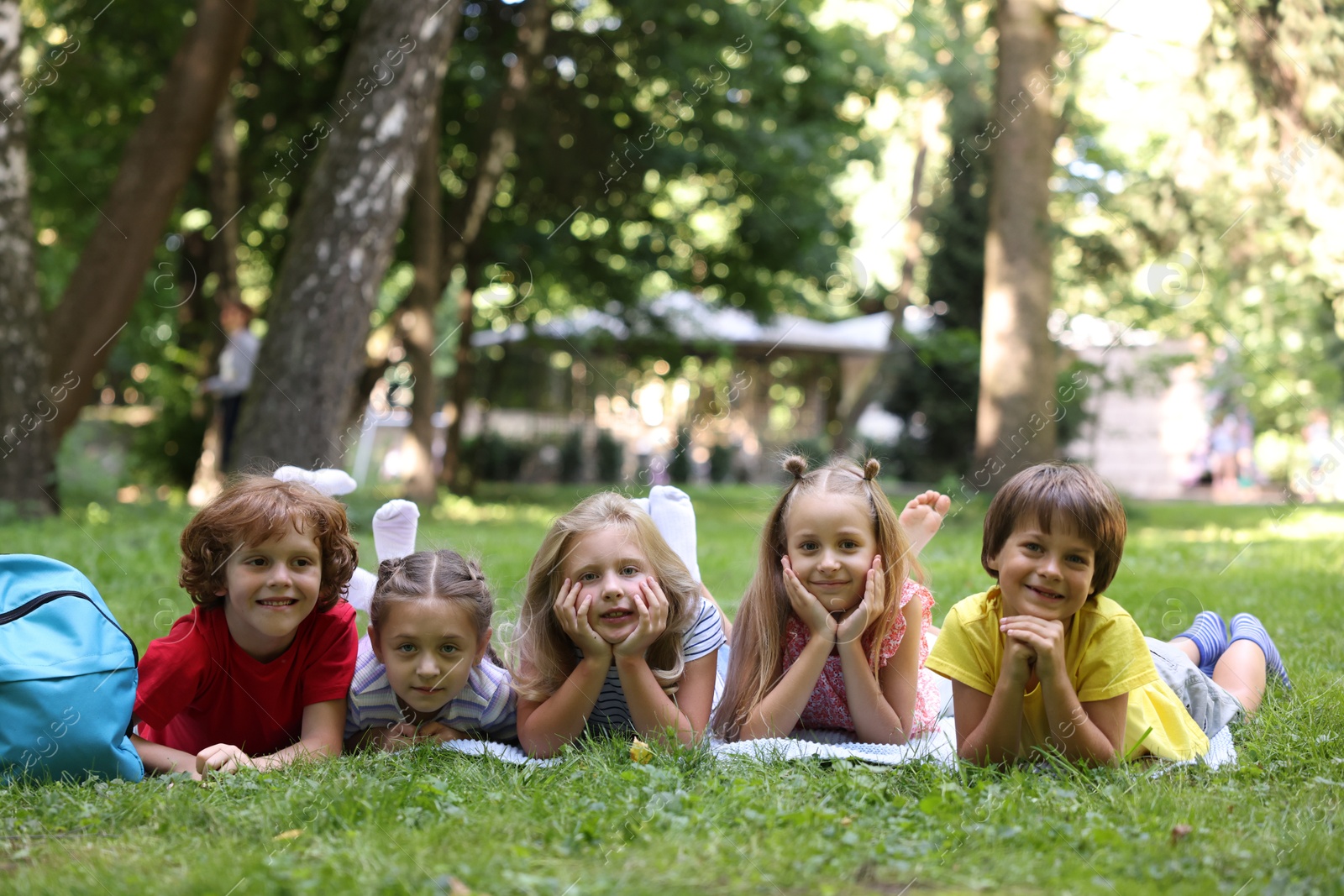 Photo of Cute little kids on green grass in park