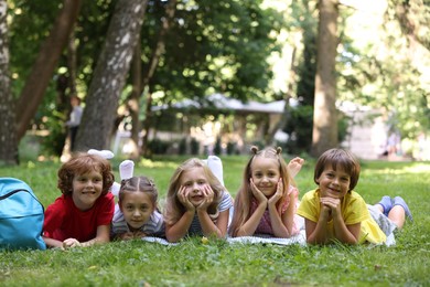 Photo of Cute little kids on green grass in park