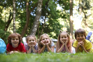 Photo of Cute little kids on green grass in park