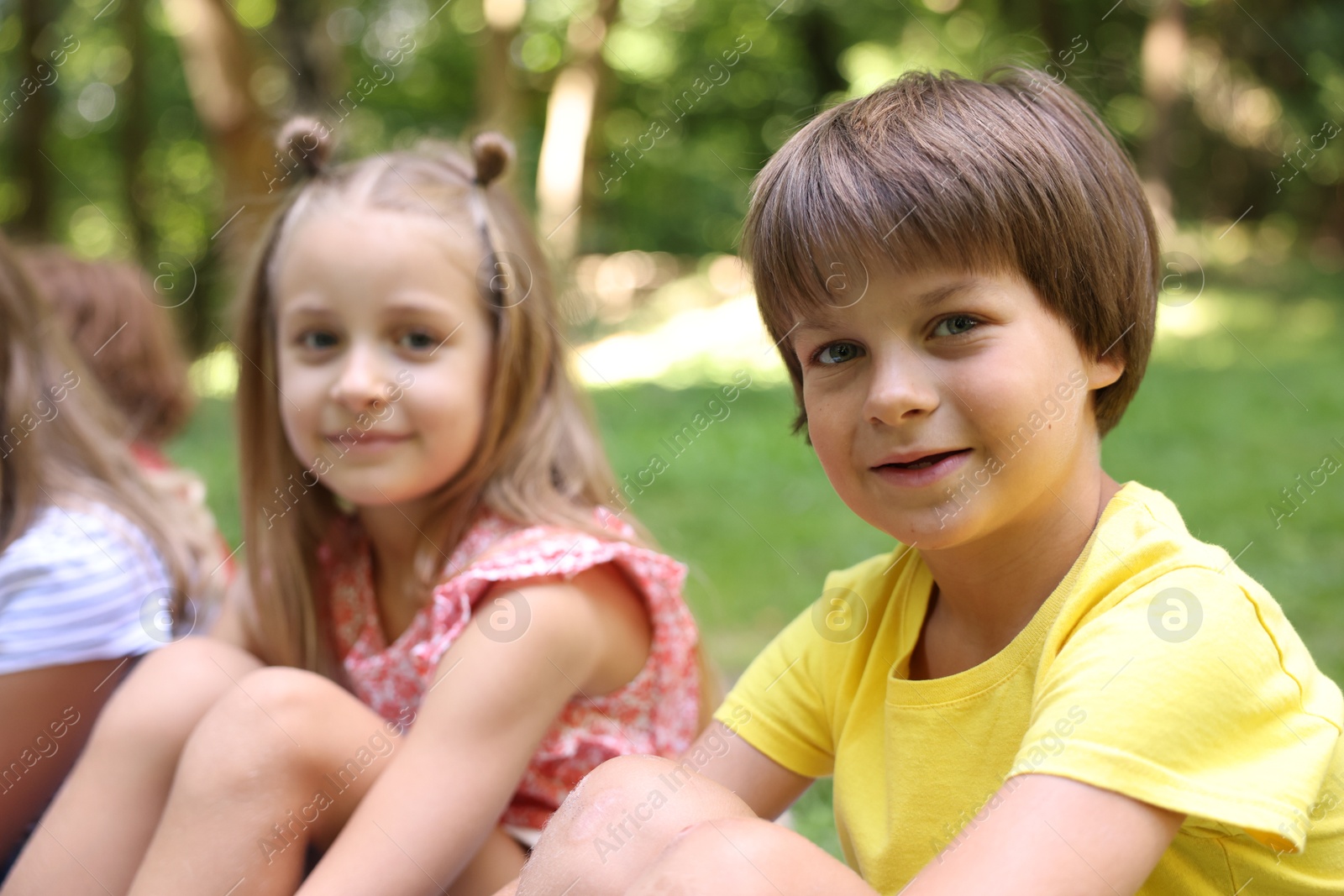 Photo of Cute little kids spending time together in park, selective focus