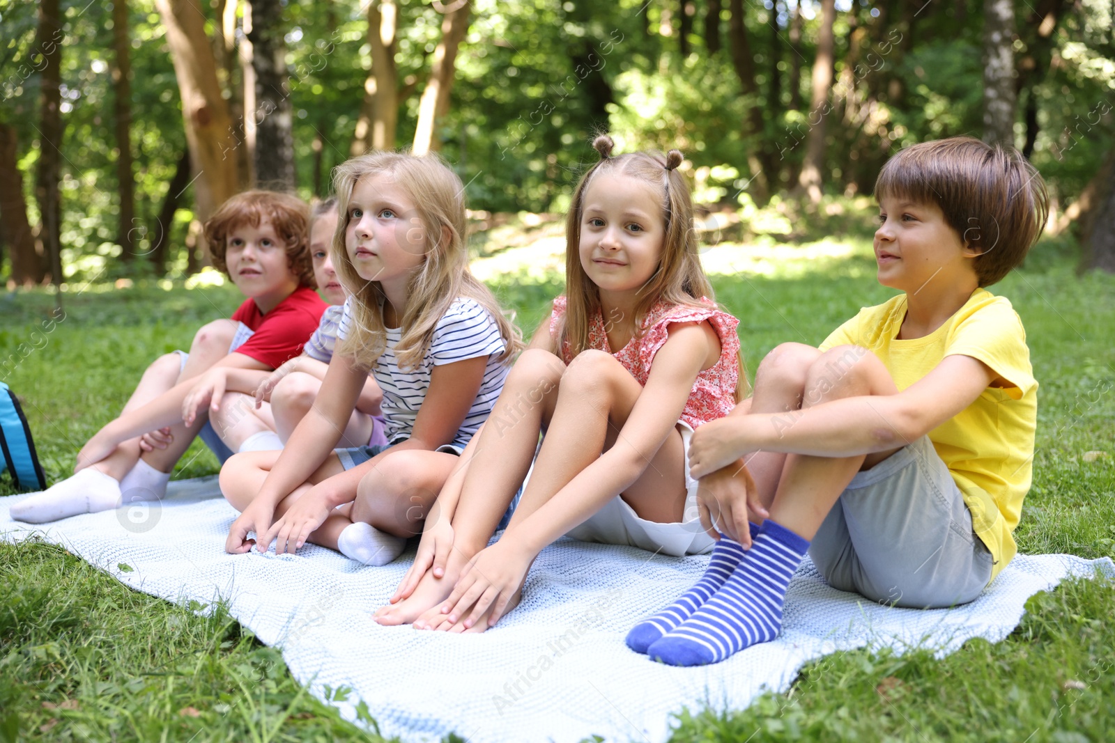 Photo of Cute little kids on green grass in park