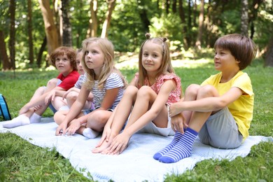 Photo of Cute little kids on green grass in park
