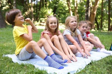 Photo of Cute little kids on green grass in park