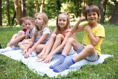 Photo of Cute little kids on green grass in park