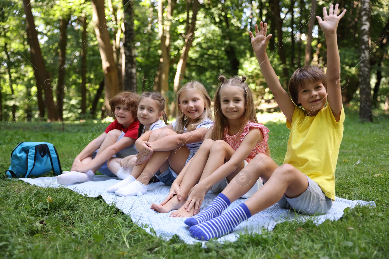 Photo of Cute little kids on green grass in park