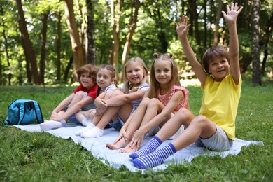 Photo of Cute little kids on green grass in park