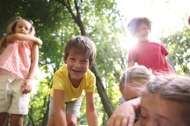 Photo of Cute little kids having fun together in park, low angle view
