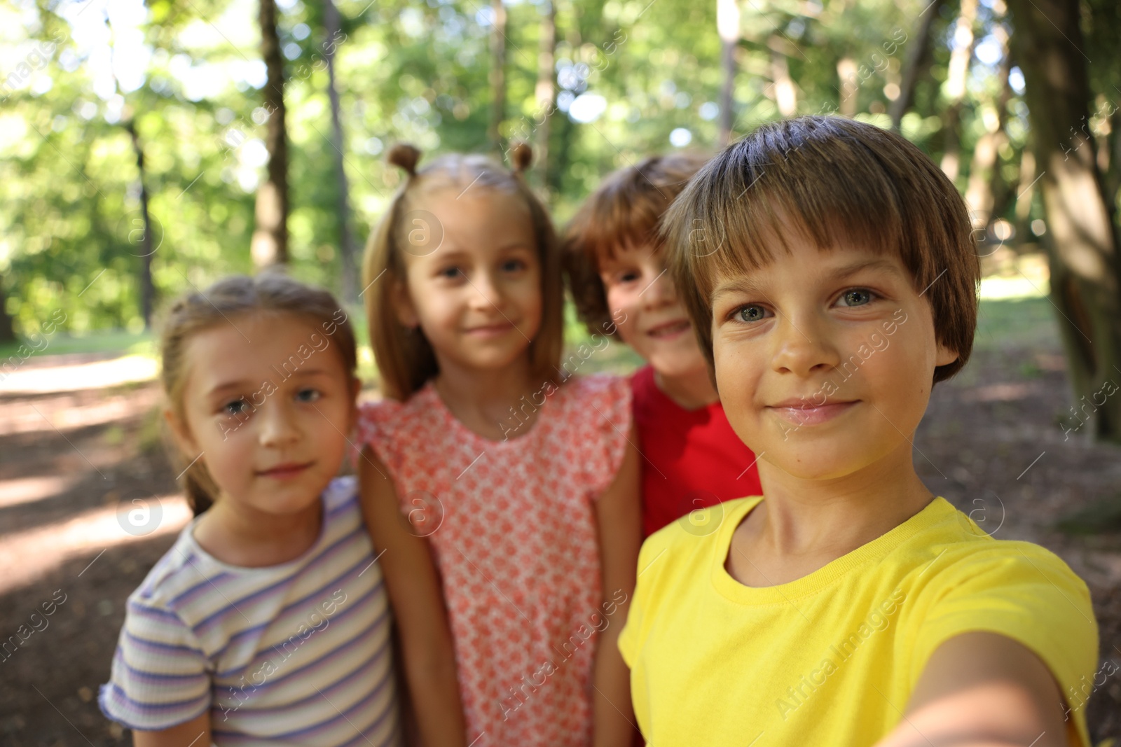 Photo of Cute little kids taking selfie in park, selective focus