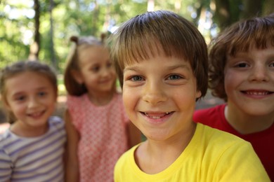 Photo of Cute little kids taking selfie in park, selective focus