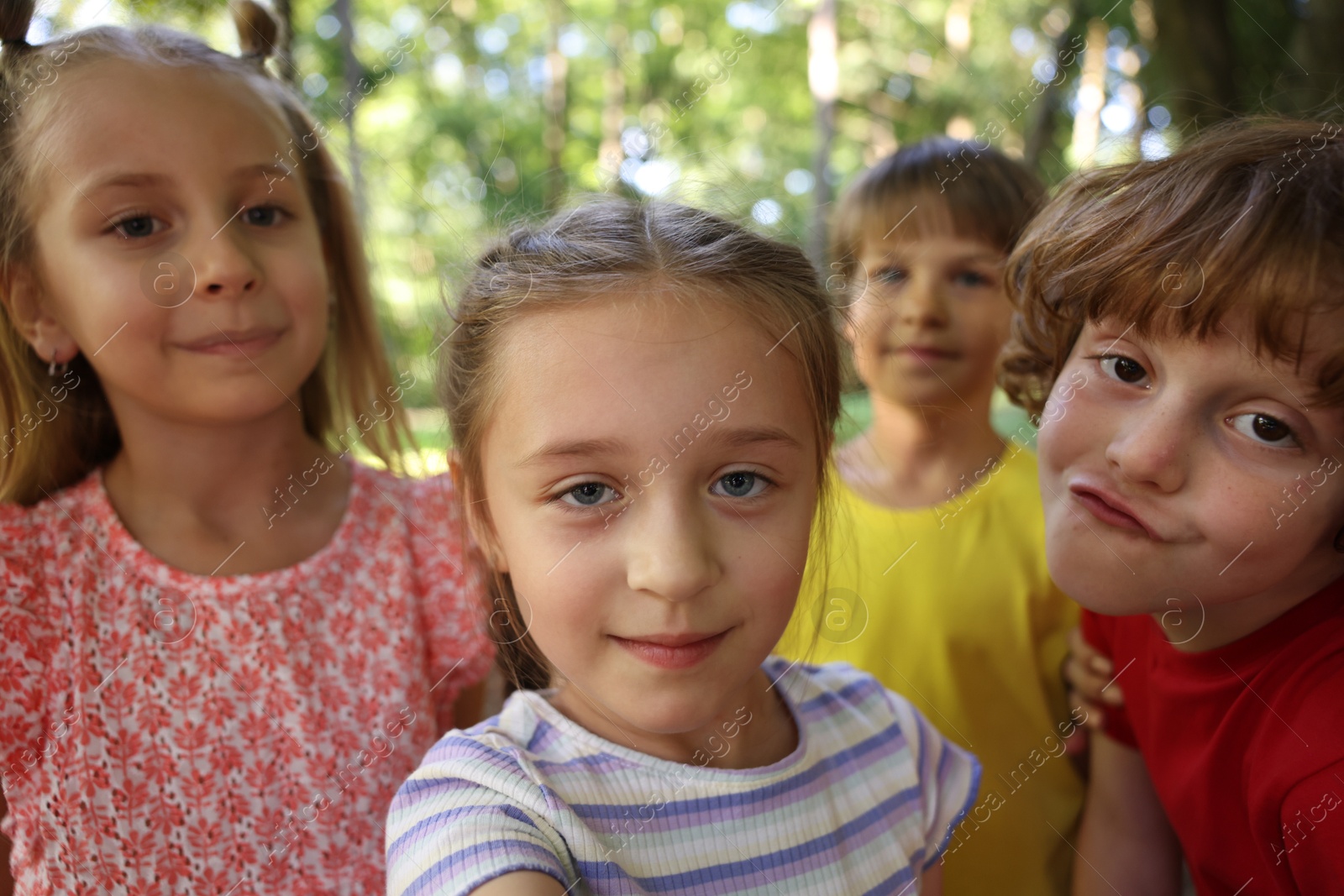 Photo of Cute little kids taking selfie in park, selective focus