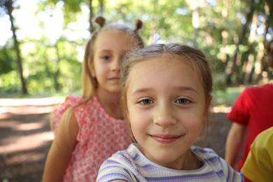 Photo of Cute little kids taking selfie in park, selective focus