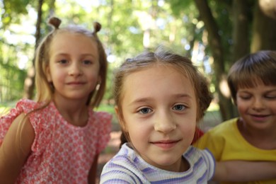 Photo of Cute little kids taking selfie in park, selective focus