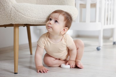 Photo of Cute little baby with toy in room