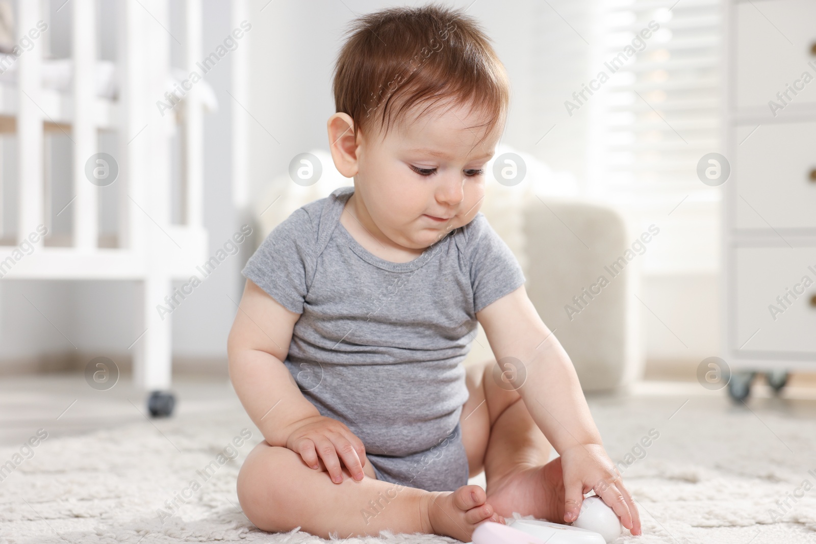Cute little baby on floor in room Photo of Cute little baby on floor in room