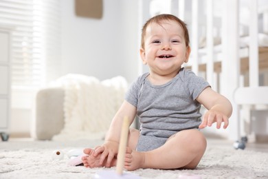 Photo of Happy little baby on floor in room. Space for text