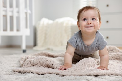 Photo of Cute little baby crawling on floor in room. Space for text