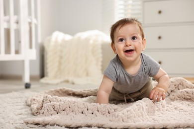 Photo of Cute little baby crawling on floor in room. Space for text