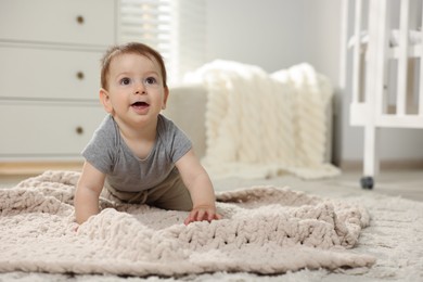 Photo of Cute little baby crawling on floor in room. Space for text