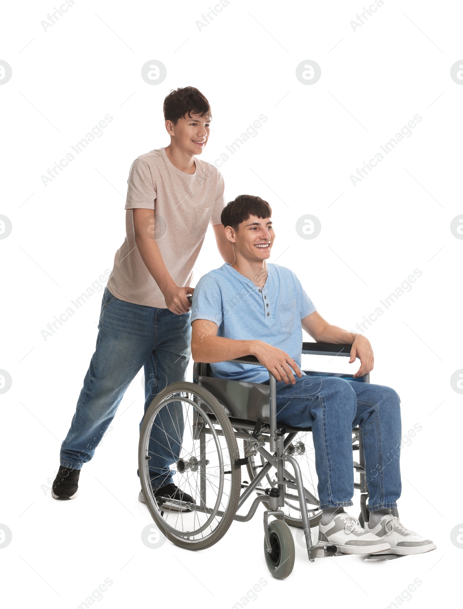 Photo of Happy young man in wheelchair and caregiver on white background