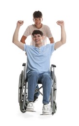 Photo of Happy young man in wheelchair and caregiver on white background