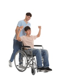 Photo of Happy young man in wheelchair and caregiver on white background