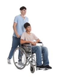 Photo of Happy young man in wheelchair and caregiver on white background
