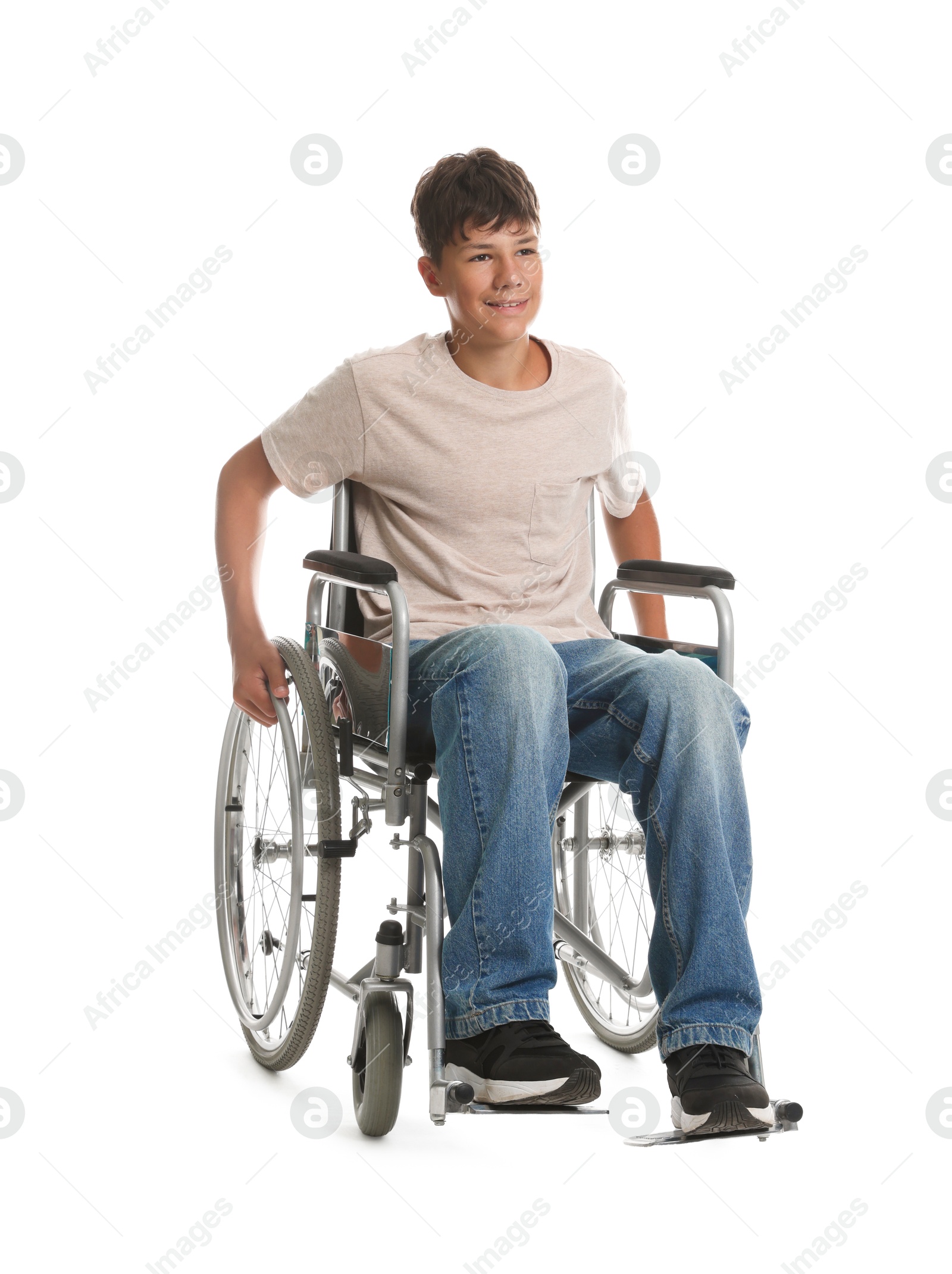 Photo of Happy teenage boy in modern wheelchair on white background