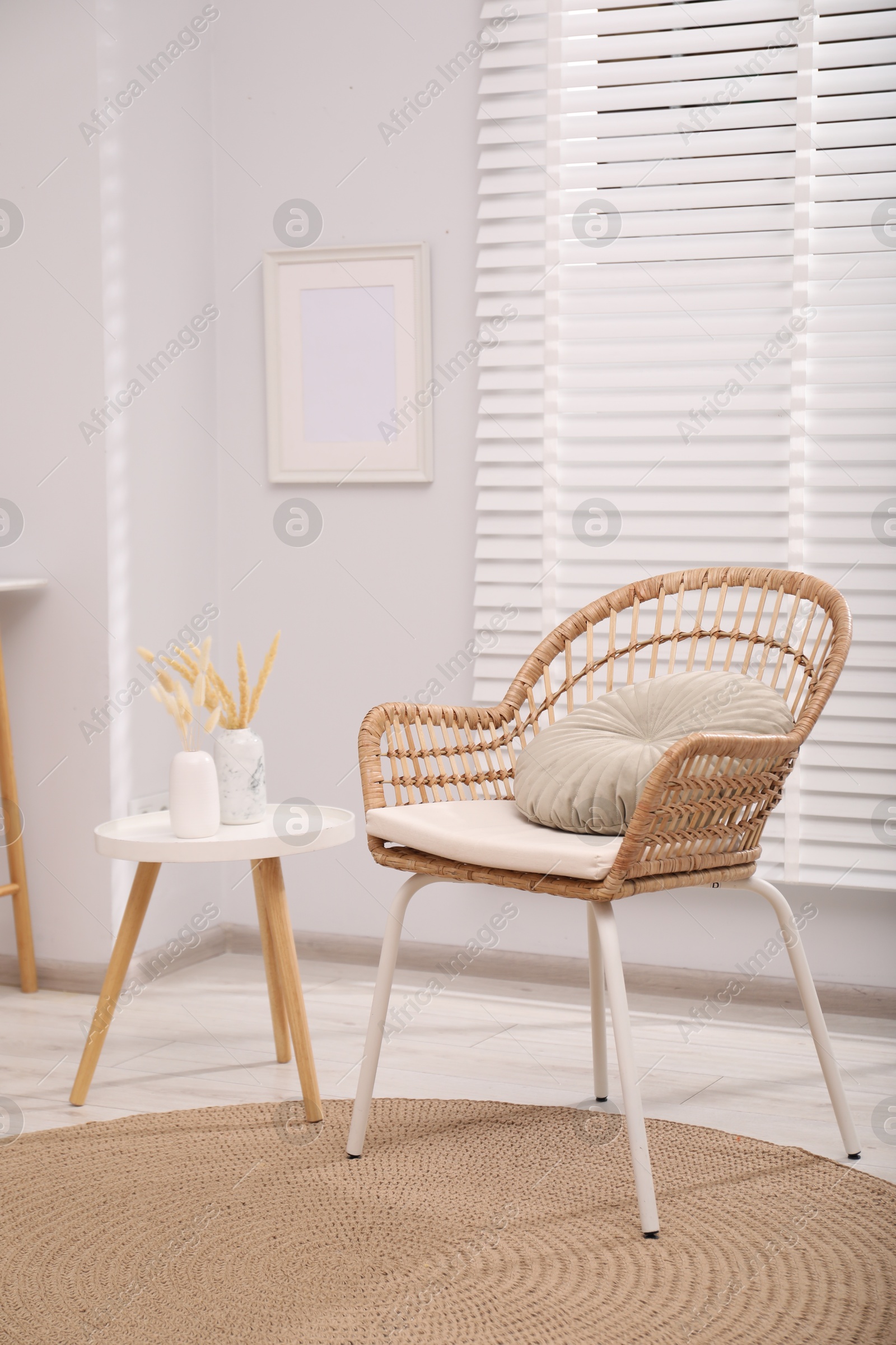 Photo of Comfortable armchair and side table in living room. Interior design