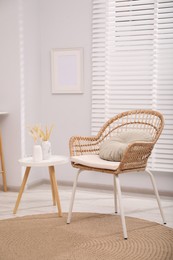 Photo of Comfortable armchair and side table in living room. Interior design