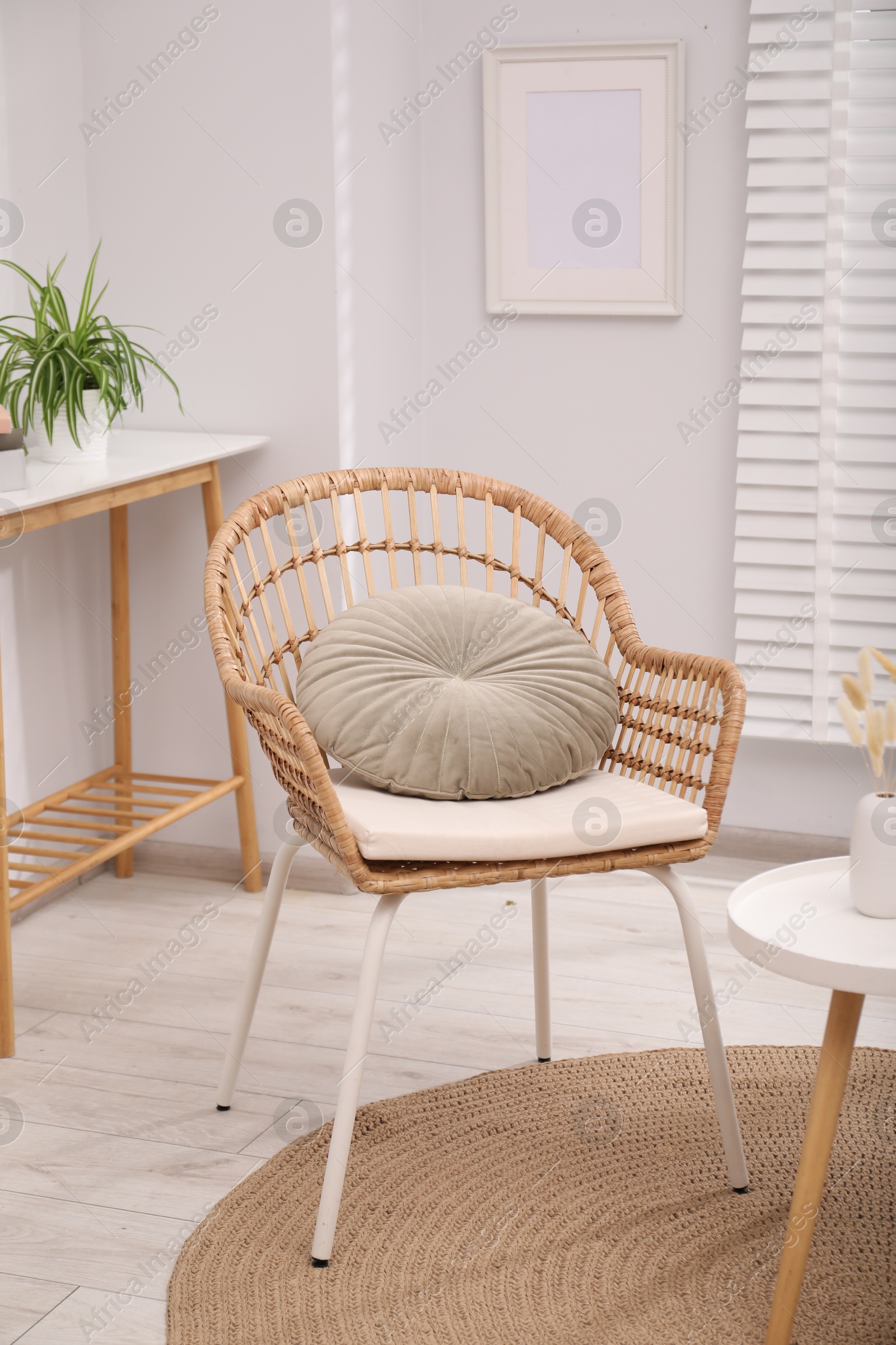 Photo of Comfortable armchair and side table in living room. Interior design