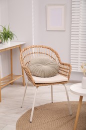 Photo of Comfortable armchair and side table in living room. Interior design
